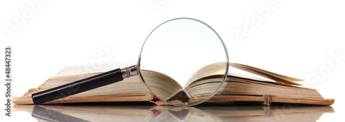 Photo: Magnifying glass and book isolated on white Magnifying glass and book isolated on white