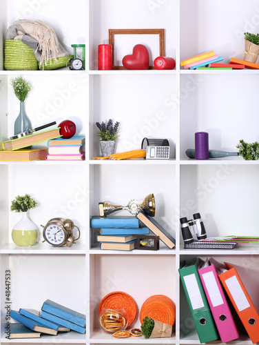 Photo: Beautiful white shelves with scattered different home related Beautiful white shelves with scattered different home related
