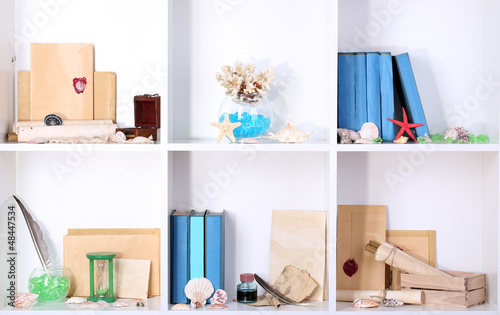 Photo: Beautiful white shelves with different travel related objects Beautiful white shelves with different travel related objects