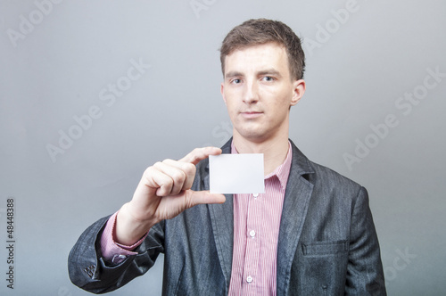 Photo: Businessman holding blank card Businessman holding blank card