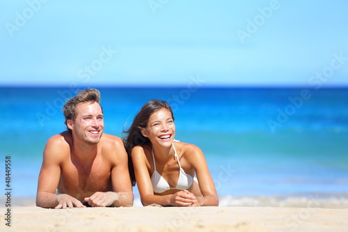 Photo: Beach couple looking Beach couple looking