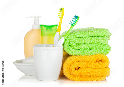 Photo: Two colorful toothbrushes, cosmetics bottles and towels Two colorful toothbrushes, cosmetics bottles and towels