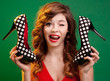 Photo: Cheerful girl holding high heels shoes Cheerful girl holding high heels shoes