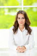 Portrait of young serious business woman at office