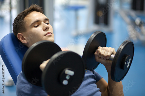 Photo: Handsome man with dumbbells Handsome man with dumbbells