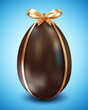 Chocolate Easter Egg with Golden Bow on blue background
