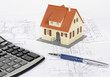 House model on a plan of a house construction.