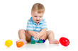 baby boy playing with toys, isolated over white