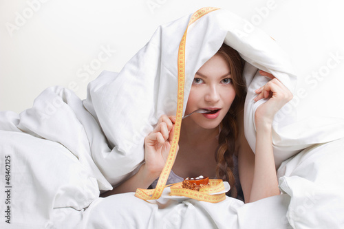 Photo: young woman eating spoon young woman eating spoon