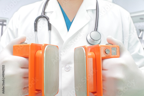 Photo: doctor with a defibrillator electrodes doctor with a defibrillator electrodes