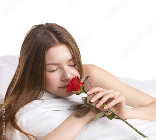 Photo: young woman with rose in a beg young woman with rose in a beg
