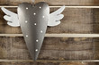 Tin heart on old wooden background