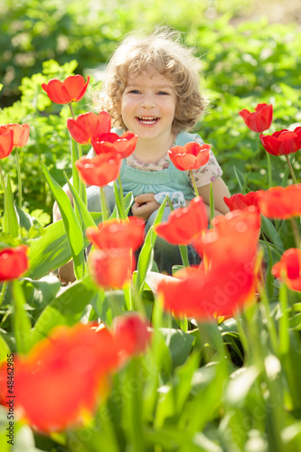 Photo: Child in flowery garden Child in flowery garden