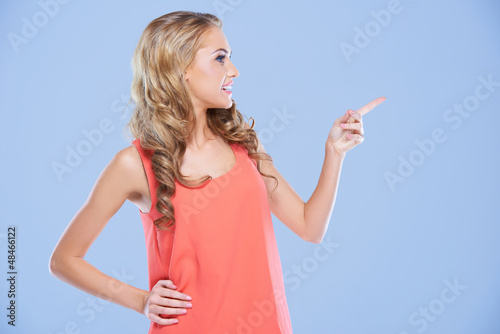 Photo: Blonde woman pointing to the right Blonde woman pointing to the right