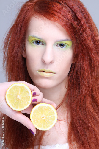Photo: young attractive woman holding lemon young attractive woman holding lemon