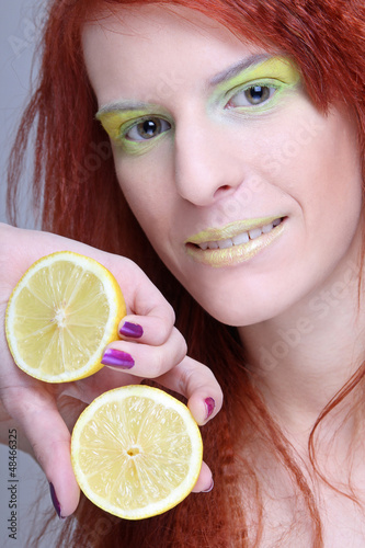 Photo: redhaired girl with lemon. close up redhaired girl with lemon. close up