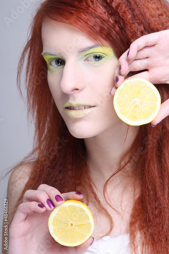 Photo: portrait of young redhaired girl with lemon portrait of young redhaired girl with lemon