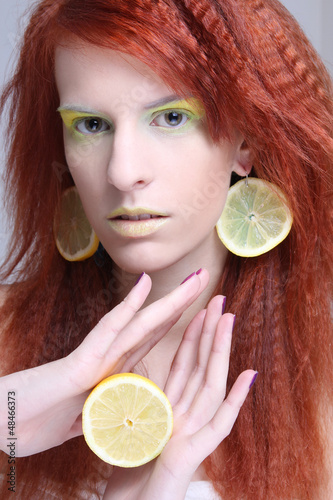 Photo: woman with lemon slices in ears woman with lemon slices in ears