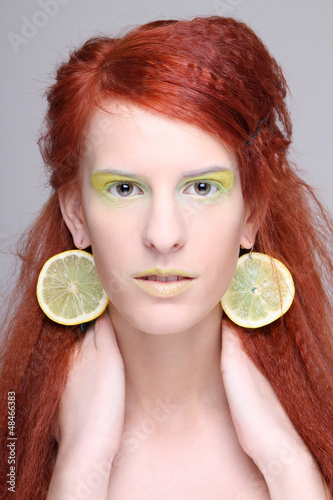 Photo: girl with lemon slices in ears girl with lemon slices in ears