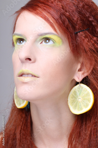 Photo: girl with lemon slices in ears dreaming girl with lemon slices in ears dreaming