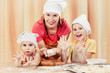 Photo: Mother with two daughters baking bread. Mother with two daughters baking bread.