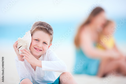 Photo: Cute boy with seashell Cute boy with seashell