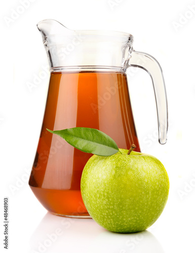 Photo: Jug of apple juice with ripe fruits isolated on white Jug of apple juice with ripe fruits isolated on white
