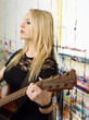 Young blond playing guitar
