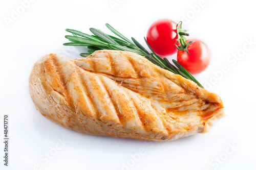 Photo: Grilled chicken breast isolated on white Grilled chicken breast isolated on white