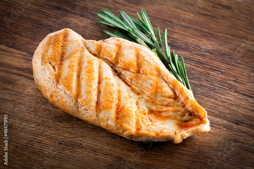 Photo: Grilled organic chicken with rosemary on wood Grilled organic chicken with rosemary on wood