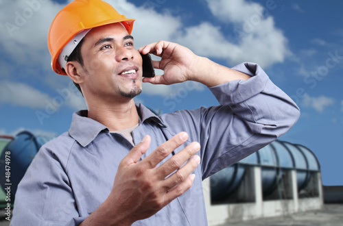 Photo: Worker With A cellphone Worker With A cellphone