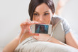 A young woman lying on the floor with her phone and shooting ( p