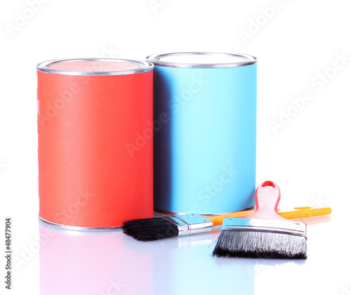 Photo: Cans of paint with paintbrushes isolated on white close-up Cans of paint with paintbrushes isolated on white close-up