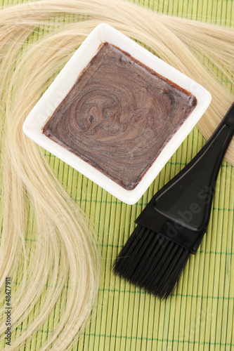 Photo: hair dye in bowl and brush for hair coloring hair dye in bowl and brush for hair coloring