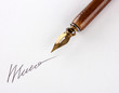 Closeup of signature (fake, not real) and ink pen, isolated