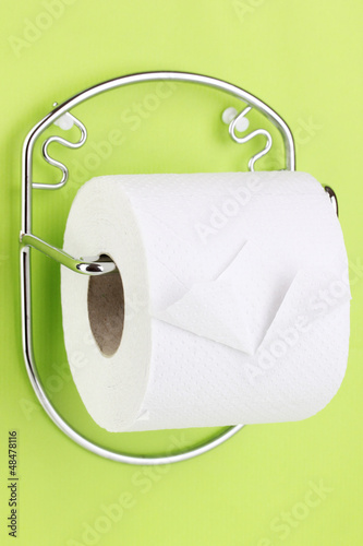 Photo: Roll of toilet paper on holder fixed to wall Roll of toilet paper on holder fixed to wall