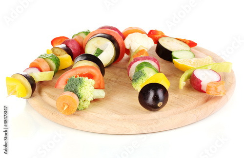 Photo: Sliced vegetables on wooden picks isolated on white Sliced vegetables on wooden picks isolated on white