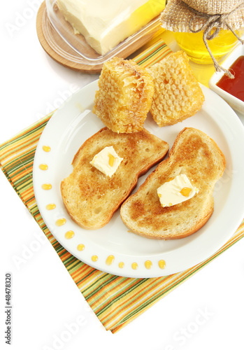 Photo: White bread toastwith honey on plate, isolated on white White bread toastwith honey on plate, isolated on white