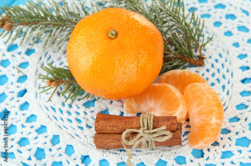 Photo: Tasty mandarines on napkin on blue background Tasty mandarines on napkin on blue background