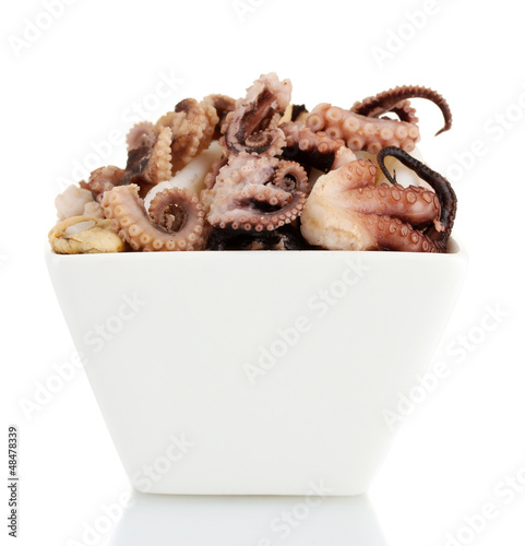 Photo: Tentacles of octopus in bowl isolated on white Tentacles of octopus in bowl isolated on white