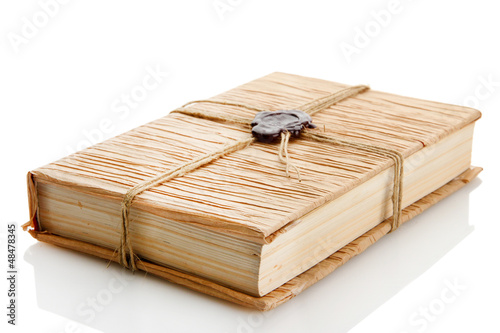 Photo: Old book with seal wax, isolated on white Old book with seal wax, isolated on white
