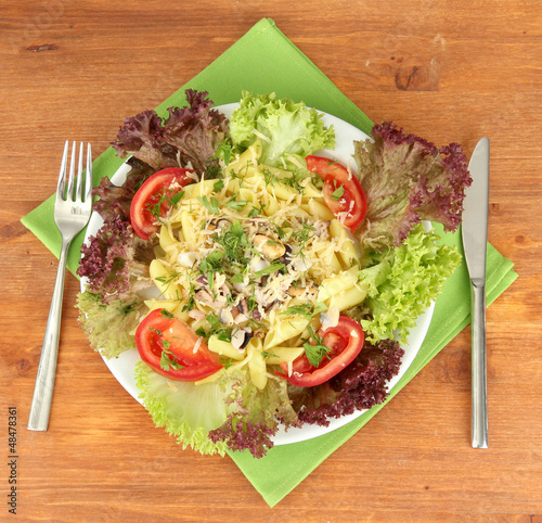 Photo: Tasty italian pasta with seafood on wooden background Tasty italian pasta with seafood on wooden background