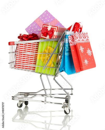 Photo: Christmas gifts and shopping in trolley isolated on white Christmas gifts and shopping in trolley isolated on white