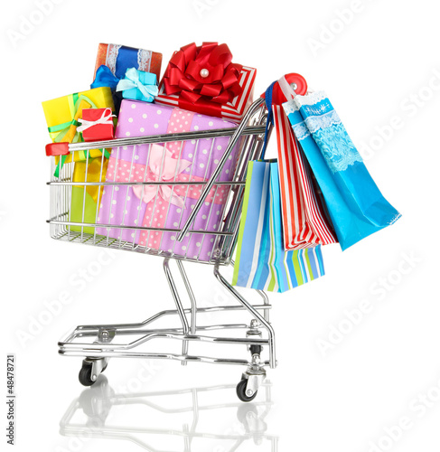 Photo: Christmas gifts and shopping in trolley isolated on white Christmas gifts and shopping in trolley isolated on white