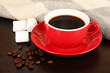 cup of coffee with scarf on table in room