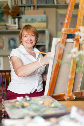Photo: woman artist paints on canvas woman artist paints on canvas