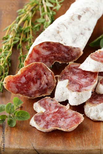 Photo: dried smoked sausage sliced on board dried smoked sausage sliced on board