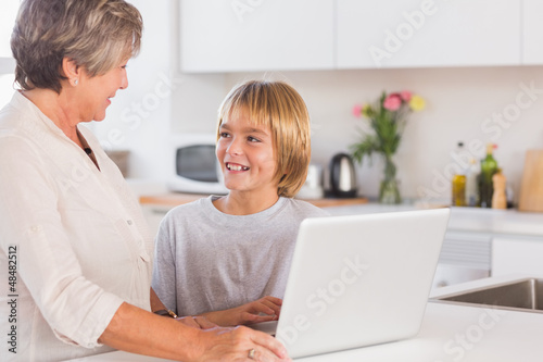 Photo: Granny and grandson using laptop and smiling Granny and grandson using laptop and smiling