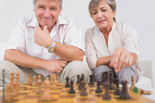 Photo: Old couple playing chess Old couple playing chess