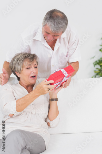 Photo: Husband giving a present to his wife Husband giving a present to his wife